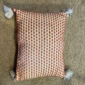 Orange and cream pillow from home goods